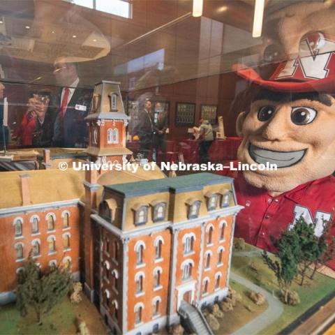 Herbie Husker looks at the replica of old University Hall. Everyone was invited to enjoy a cupcake and join in the festivities with their Husker friends at the Wick Alumni Center, Friday February 15th. The Nebraska Charter was available to view, along with other historical items. Copies of Dear Old Nebraska U could be purchased and signed. Charter Day at the Wick Alumni. February 15th, 2019. Photo by Gregory Nathan / University Communication.